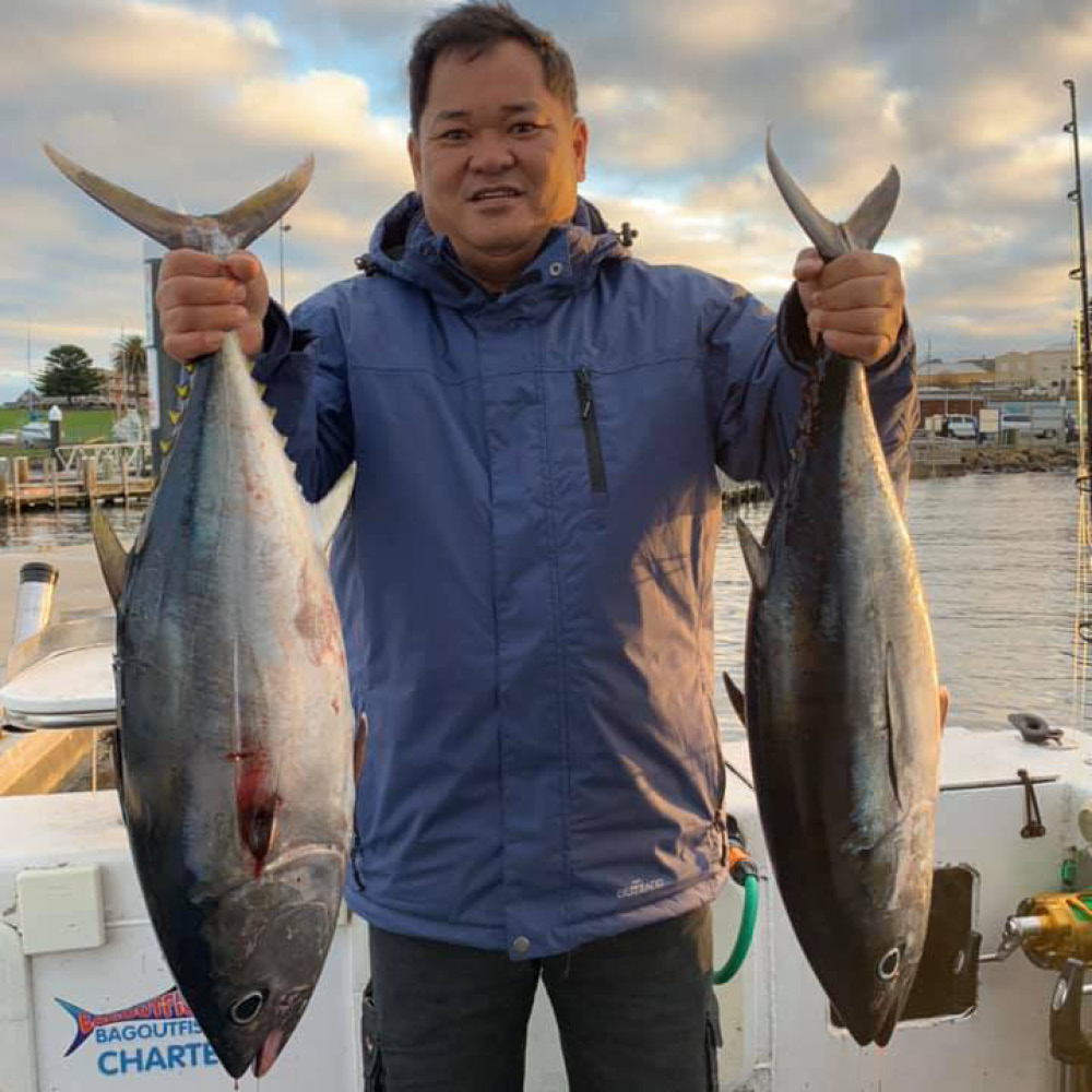 happy man holding two caught fish