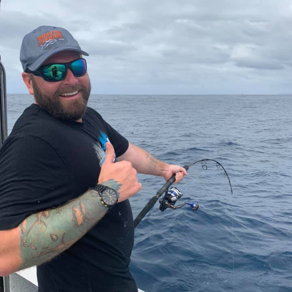 happy man deep sea fishing on a bag out fishing trip