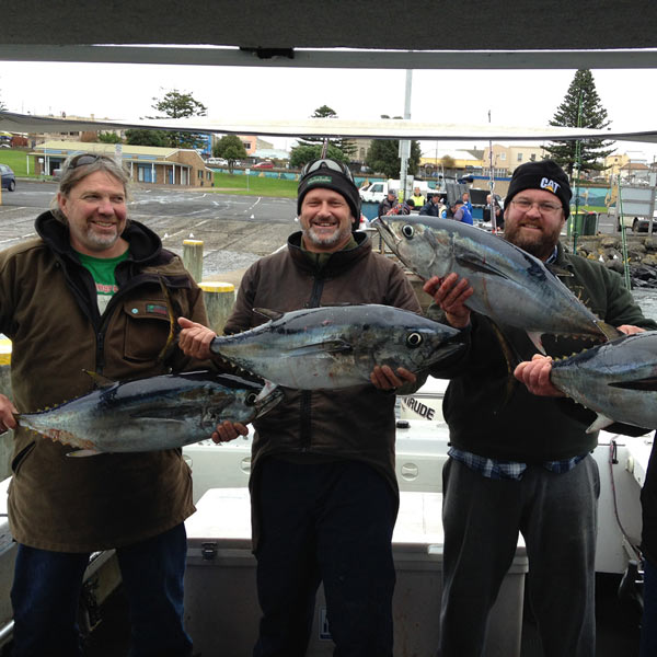 three happy bagout tuna fishing charter customers