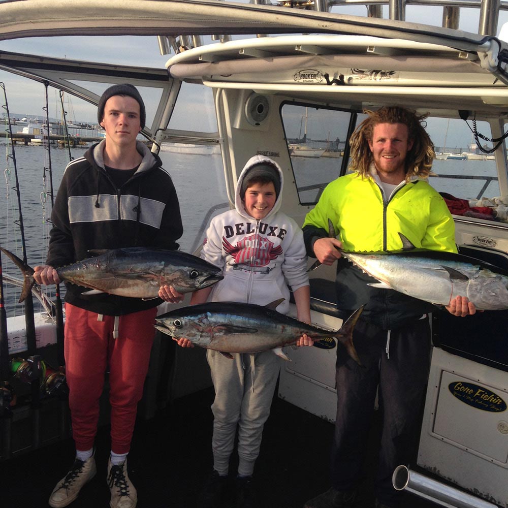 three happy bagout tuna fishing charter customers