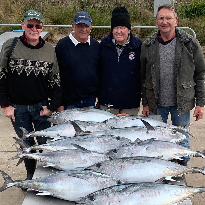 four happy bagout tuna fishing charter customers