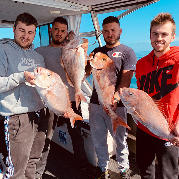 four customers holding caught fish